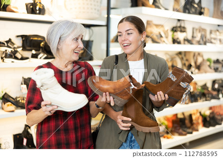 Two women are shopping in shoe store 112788595