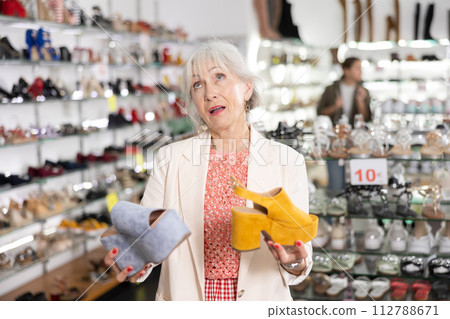 Mature woman who came to shoe store is going to try on shoes 112788671