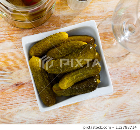 Pile of pickled cucumbers served on table 112788714