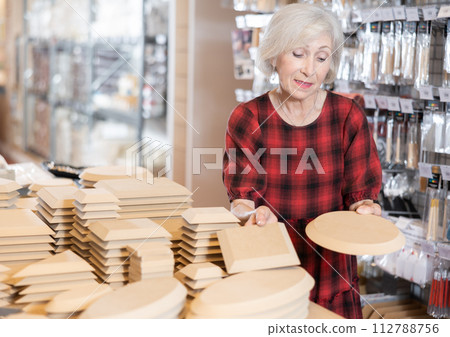 Buying wooden molds for clay products in pottery shop Buying wooden molds for clay products in pottery shop 112788756