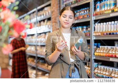 Young woman chooses paint and pottery tools 112788836