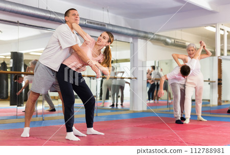 Woman and man practicing self defense techniques 112788981