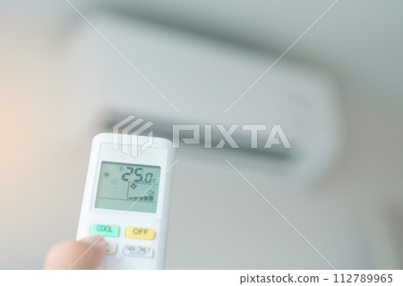 hand operating remote controller for adjust Air conditioner inside the room of office or house 112789965