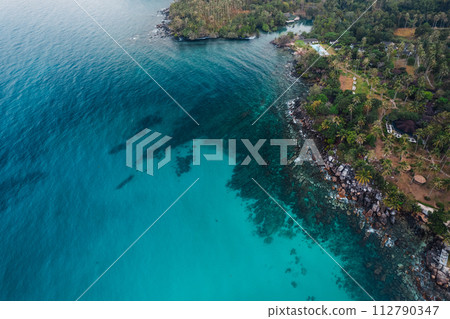 Crystal clear turquoise water under a blue sky Crystal clear turquoise water under a blue sky 112790347