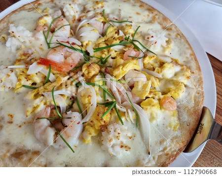 a pizza topped with seafood a pizza topped with seafood 112790668