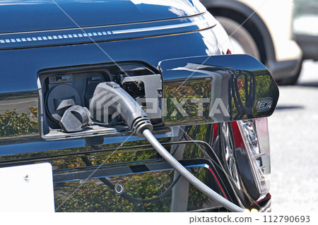 Electric car under charge Electric car under charge 112790693
