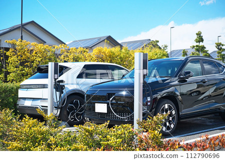 Electric car under charge 112790696