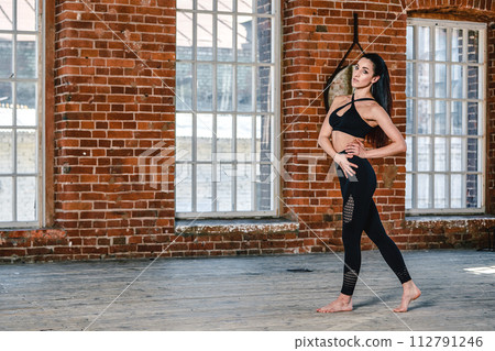 portrait of a pretty sporty woman indoor 112791246