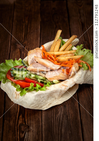 Turkish and Arabic Traditional Ramadan mix kebab plate. Kebab beef on lavash bread with sauce and vegetables. 112791248
