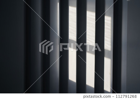 Close up view of an abstract black background with geometric vertical slats, backdrop with copy space, light and shadow pattern. Stylish template, mock up for your design, art, poster, presentation. 112791268