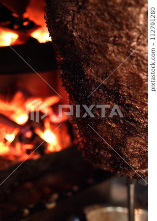 Close up shot of stacked meat roasting to be used in preparation of traditional Greek dish gyros or Turkish durum doner. shawarma 112791280