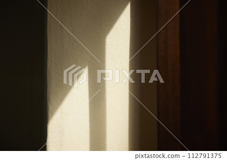 Comfortable rest by the sunny window. A background with sunlight and shadows that can be used in various designs. 112791375