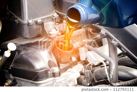 Refueling and pouring oil quality into the engine motor car Transmission and Maintenance Gear .Energy fuel concept. Refueling and pouring oil quality into the engine motor car Transmission and Maintenance Gear .Energy fuel concept. 112793111