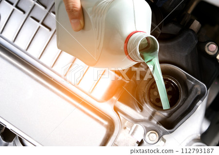 Refueling and pouring oil quality into the engine motor car Transmission and Maintenance Gear .Energy fuel concept. Refueling and pouring oil quality into the engine motor car Transmission and Maintenance Gear .Energy fuel concept. 112793187