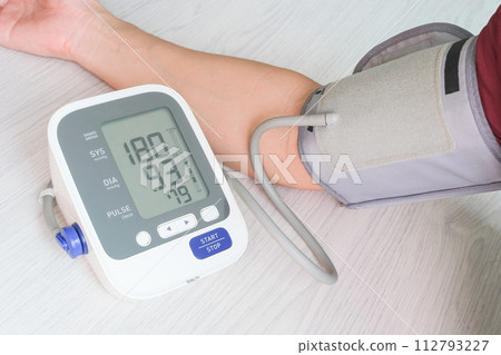 Man check blood pressure monitor and heart rate monitor with digital pressure gauge. Health care and Medical concept Man check blood pressure monitor and heart rate monitor with digital pressure gauge. Health care and Medical concept 112793227