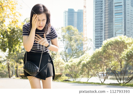 Tired asian woman with dizziness,Heat stroke,walking outdoor on sunny day,hot weather,high temperature in summer,sweaty and thirsty,Arrhythmia symptoms,heart beats with an irregular or abnormal rhythm Tired asian woman with dizziness,Heat stroke,walking outdoor on sunny day,hot weather,high temperature in summer,sweaty and thirsty,Arrhythmia symptoms,heart beats with an irregular or abnormal rhythm 112793393