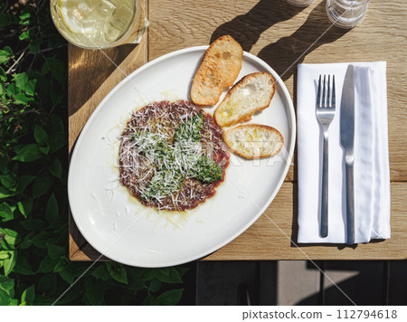 Red carpaccio with pesto sauce and toast Red carpaccio with pesto sauce and toast 112794618