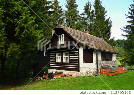 Beautiful old traditional house in the mountains in the Czech Republic. Cottage in nature. Beautiful old traditional house in the mountains in the Czech Republic. Cottage in nature. 112795168