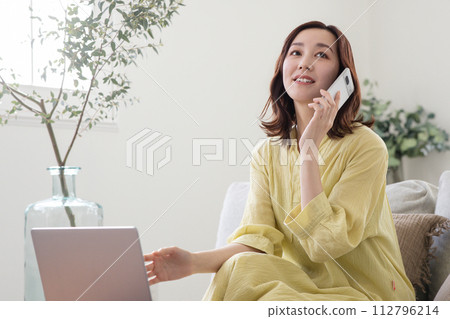 A woman who speaks with a smartphone A woman who speaks with a smartphone 112796214