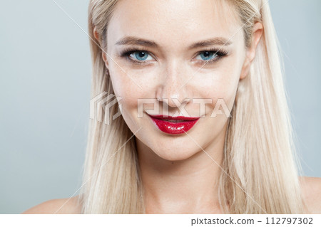 Smiling woman face close-up. Blonde model with fresh clear skin and healthy silky hair  112797302