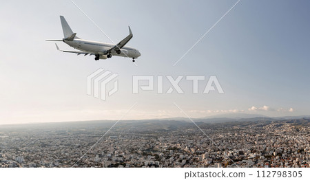 Passengers commercial airplane flying above Limassol city, Cyprus Passengers commercial airplane flying above Limassol city, Cyprus 112798305