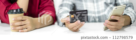 E-commerce Concept. Happy couple holding credit card enjoying doing online shopping and using laptop enter their card number in-app to purchase and payment in internet store 112798579