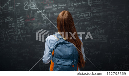 Teenager in class on background of blackboard Teenager in class on background of blackboard 112798869
