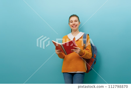 teenager on color paper wall background 112798870