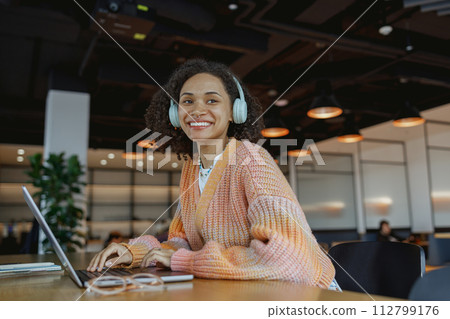 Woman smiles at event while building leisure with laptop on wood table 112799176