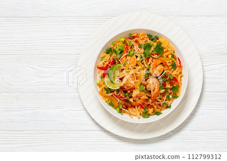 pad thai with shrimps, peanuts, eggs, bean sprouts pad thai with shrimps, peanuts, eggs, bean sprouts 112799312
