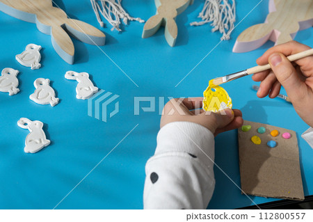 Master class of coloring Creator is using white air dry clay for making decor to EASTER holiday. Creating hobby recreation activity that involves fingers. DIY crafting 112800557