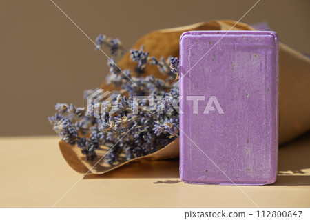 Handmade aromatic spa lavender soap. Natural additives and extracts. Bar of lavender soap with dried flowers. Beauty treatment product herbal ecological organic cosmetics Handmade aromatic spa lavender soap. Natural additives and extracts. Bar of lavender soap with dried flowers. Beauty treatment product herbal ecological organic cosmetics 112800847