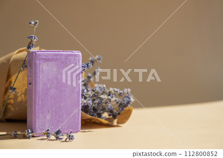 Handcrafted purple lavender soap with lavender flowers. Natural hydrating moisturiser softness cosmetic. Organic calming beauty skincare product. Herbal self care wellness alternative soap Handcrafted purple lavender soap with lavender flowers. Natural hydrating moisturiser softness cosmetic. Organic calming beauty skincare product. Herbal self care wellness alternative soap 112800852