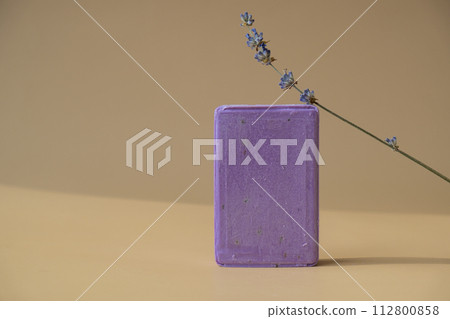 Handcrafted purple lavender soap with lavender flowers. Natural hydrating moisturiser softness cosmetic. Organic calming beauty skincare product. Herbal self care wellness alternative soap Handcrafted purple lavender soap with lavender flowers. Natural hydrating moisturiser softness cosmetic. Organic calming beauty skincare product. Herbal self care wellness alternative soap 112800858