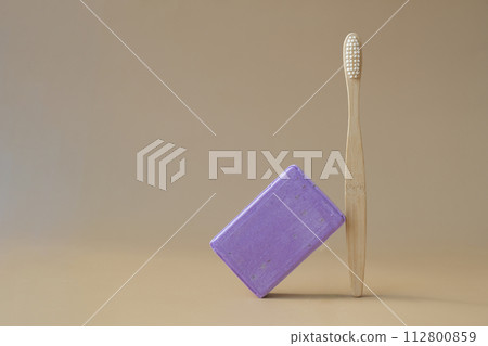 Eco friendly bamboo toothbrush and Handmade aromatic spa lavender soap. Natural additives and extracts. Bar of lavender soap with dried flowers. Beauty treatment product herbal ecological organic Eco friendly bamboo toothbrush and Handmade aromatic spa lavender soap. Natural additives and extracts. Bar of lavender soap with dried flowers. Beauty treatment product herbal ecological organic 112800859