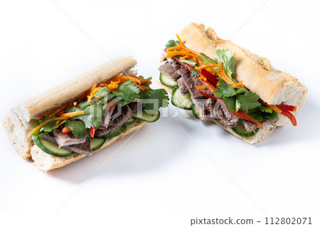 Vietnamese pork banh mi sandwich isolated on white background Vietnamese pork banh mi sandwich isolated on white background 112802071