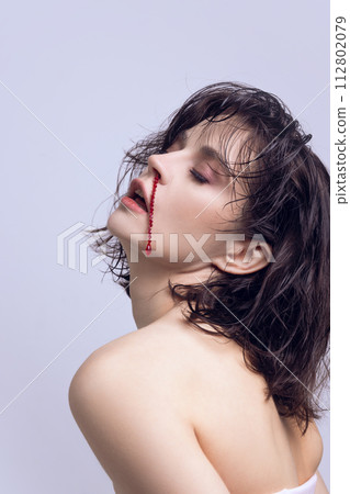 Elegant, beautiful young woman with jewelry imitating blood nose. Aesthetic medicine impact on self acceptance 112802079