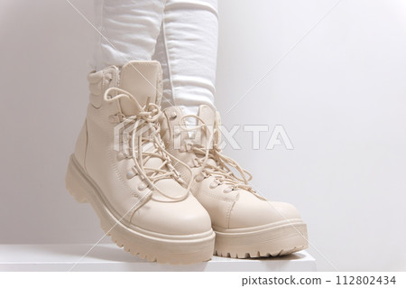 Light shoes women's boots with laces with high soles on a white background classic fashion show for purchase for winter autumn shoes store beige color milky color. High quality  112802434