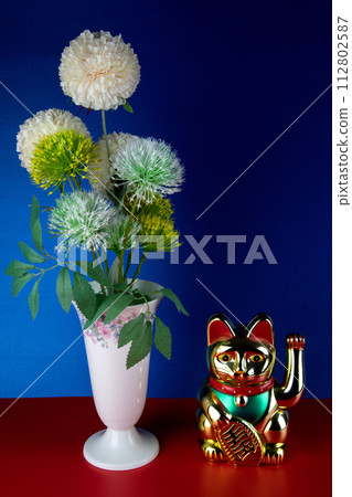 Artificial Flowers in a Porcelain Vase with Gold Coloured Maneki Neko Waving Lucky Cat 112802587