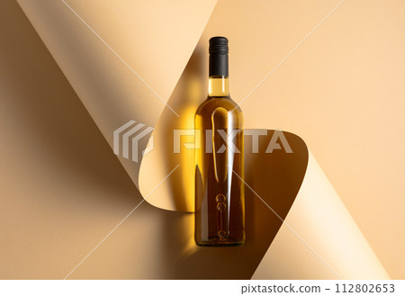 Bottle of white wine on a beige background. 112802653