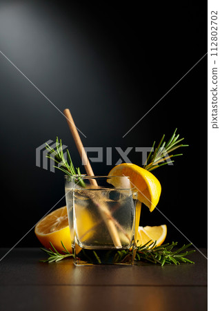 Cold refreshing drink with ice, lemon, and rosemary. Cold refreshing drink with ice, lemon, and rosemary. 112802702