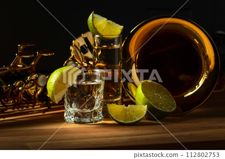 Saxophone and tequila with lime slices. 112802753