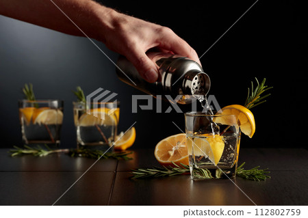 Cocktail Gin and Tonic with lemon and rosemary. Cocktail Gin and Tonic with lemon and rosemary. 112802759