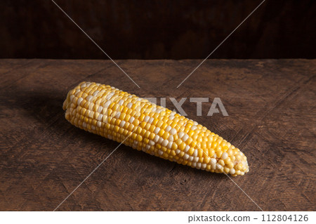 Cob sweet corn on wooden background.. 112804126