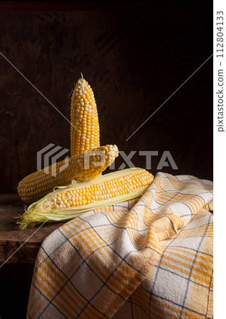 Several cobs sweet corn on wooden background.. Several cobs sweet corn on wooden background.. 112804133
