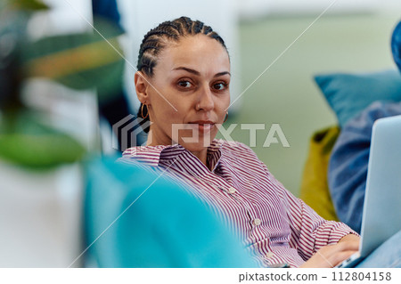 A modern programmer discussing future business projects with colleagues in a modern startup office 112804158