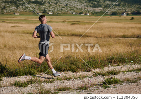 Determined Stride: Athletic Man Embarks on Marathon Preparation with Resolve. Determined Stride: Athletic Man Embarks on Marathon Preparation with Resolve. 112804356