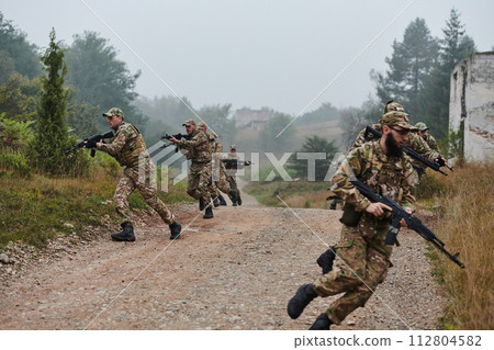A disciplined and specialized military unit, donned in camouflage, strategically patrolling and maintaining control in a high-stakes environment, showcasing their precision, unity, and readiness for 112804582