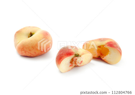 Whole and half of saturn peach or flat peaches isolated on white background with clipping path.. Whole and half of saturn peach or flat peaches isolated on white background with clipping path.. 112804766