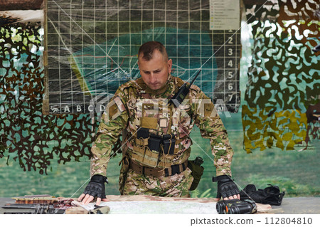 The esteemed leader of an elite military unit, strategic brilliance unfolds as he meticulously devises tactical plans for the upcoming military operation, surrounded by cutting-edge technology and a The esteemed leader of an elite military unit, strategic brilliance unfolds as he meticulously devises tactical plans for the upcoming military operation, surrounded by cutting-edge technology and a 112804810